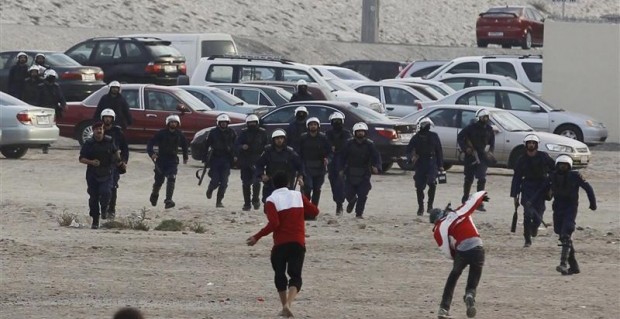 Anti-government protesters throw rocks at riot police in Manama