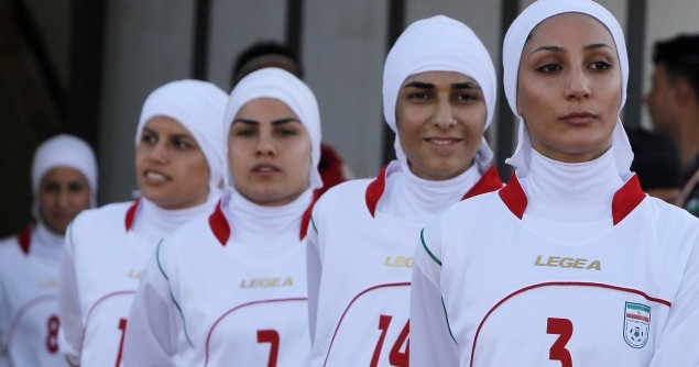 The Iranian women's national soccer team walk to the pitch before withdrawing from their qualifying match against Jordan for the 2012 London Olympic Games in Amman
